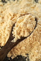 Whey protein powder on a spoon
