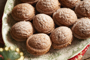 Baked homemade Christmas cookies in the form of nuts filled with cream on a plate