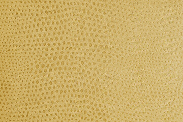 Cloth structure of jacquard yellow fabric with abstract shabby spotted embossed texture closeup, macro. Upholstery, decorative cloth structure, home decor canvas. Background, backdrop, wallpaper.