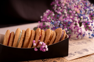 photo, assorted, assortment, box, biscuit, dessert, sandwich, cookie, color, flavor, sweet, purple, pink, blue, white, flower, filling, background, pastel, decorative, setting, variety, arrangement