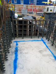 Foundation rebar grid with concrete continuous plastic spacers for consistent alignment and concrete cover. Reinforcement setup for structural stability on construction site.