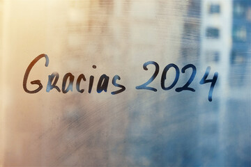 lettering thanks Gracias in Spanish is thanks in english and numbers 2024 twenty twenty-four paint...