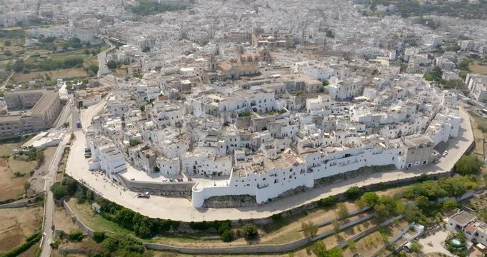Aerial view of the city of Ostuni, also known as The White Town. It is located on a hill in the province of Brindisi, in Puglia, Italy. Surrounding the city is the Murgia countryside.