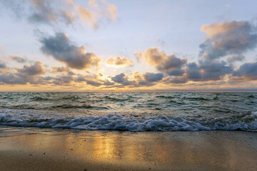Seascape at sunset. Bright sundown on the sea shore. Sunset on the Baltic Sea.