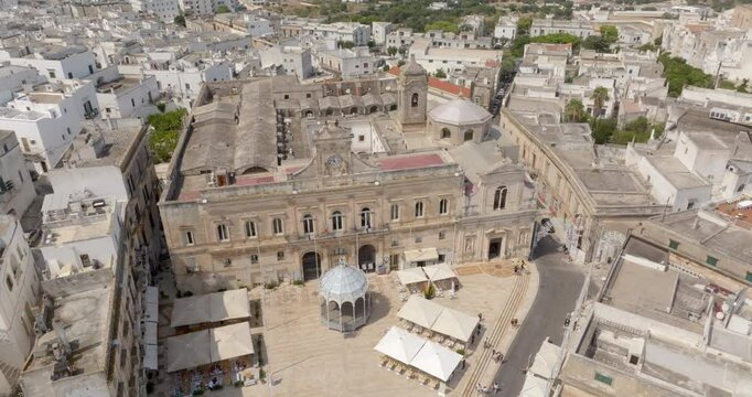Aerial view of the church of San Francesco, the main square and the town hall of Ostuni, in the province of Brindisi, in Puglia, Italy. They are located in the historic center of the city.