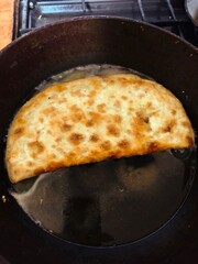 Ruddy, fragrant, tasty, fried cheburek with meat