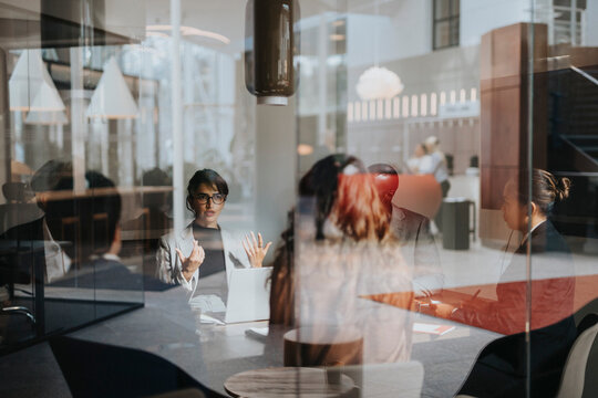 Businesswoman discussing strategy with male and female colleague at office