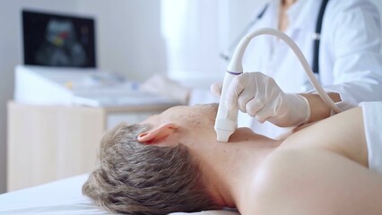Doctor woman wearing white medical coat performing neck ultrasound exam on male patient. Medicine service concept