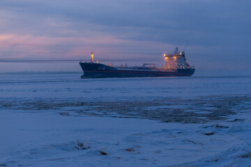 A massive and large ship is currently floating majestically on the surface of a frozen body of...