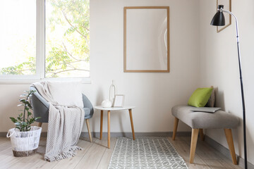Interior of living room with soft bench, armchair and table