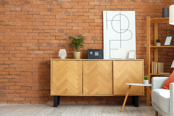 Interior of living room with sofa, coffee table and safe box on commode