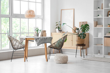 Interior of stylish modern living room with big shelving unit, table and chairs