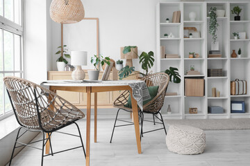 Interior of stylish modern living room with big shelving unit, table and chairs