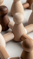 Wooden figures linked by white circles illustrate a network concept representing teamwork and collaboration