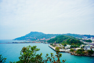 Kaohsiung, Taiwan, Republic of China, 01 25 2024: The landscape of Kaosiung port harbor, downtown, shiziwan (siziwan, xiziwan), and shoushan mountain seen from Qijin lighthouse