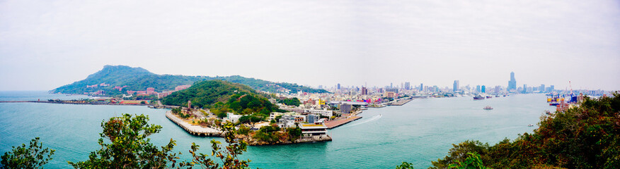 Fototapeta premium Kaohsiung, Taiwan, Republic of China, 01 25 2024: The landscape of Kaosiung port harbor, downtown, shiziwan (siziwan, xiziwan), and shoushan mountain seen from Qijin lighthouse