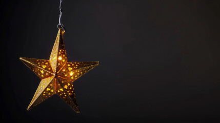 Gold star light hanging against a dark background