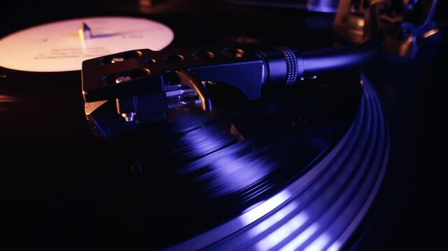Classic Vinyl Record Playing With blue light at night. Macro. Turntable spin, LP
