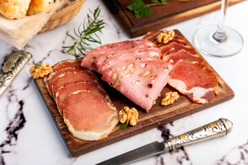 cold cuts table with assorted cheeses, Sardinian provolone and flavoured with oregano and olives,...