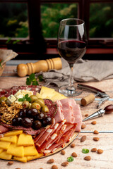 cold cuts table with assorted cheeses, Sardinian provolone and flavoured with oregano and olives, homemade bread with loin, ham, pork shoulder, bacon, salami, mortadella with nuts and a variety of col