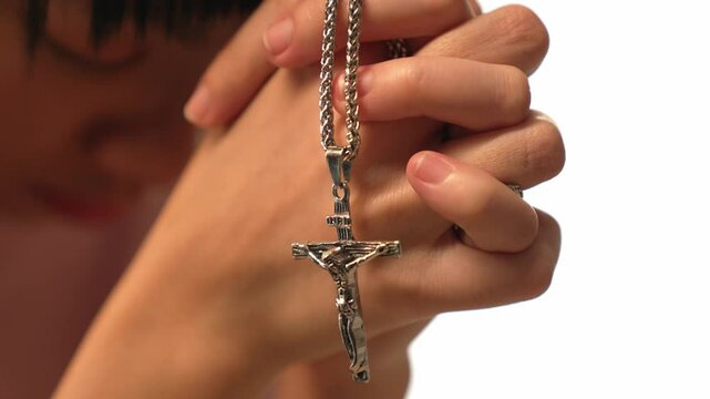 Sense of devotion and spiritual fulfill with christian catholic follower immerse in faith. Slow motion christian holding holy cross while praying to worship the god. Burgeoning