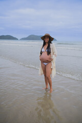 a pregnant woman on the beach