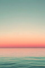 Fototapeta premium A serene ocean view at sunset, showcasing soft pastel colors blending from blue to peach across the horizon, evoking a sense of tranquility and peacefulness.