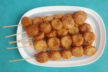Bitso Bitso, a Filipino delicacy made with fried rice flour dough then coated with coconut cream and muscovado sugar syrup.