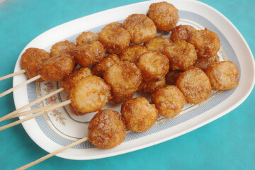 Bitso Bitso, a Filipino delicacy made with fried rice flour dough then coated with coconut cream and muscovado sugar syrup.