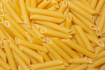 Uncooked Penne Rigate Pasta: A Culinary Canvas of Penne Macaroni, Creating a Lively and Textured Background for Gourmet Cooking. Dry Pasta. Raw Macaroni - Top View, Flat Lay