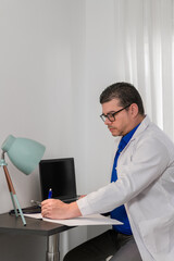  Male doctor writing notes in a modern office setting