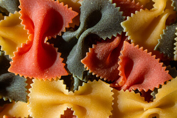 Uncooked Vibrant Colored Farfalle Pasta: A Culinary Canvas of Multicolored Bow-Tie Macaroni,...