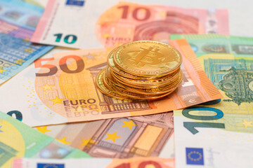 A Stack of Bitcoin Coins on the Euro Banknotes. Money Saving, Cryptocurrency, Blockchain and Anonymous Payments Concept