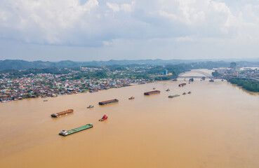 Barges carrying coal cross the Mahakam River, in Samarinda City, East Kalimantan, Indonesia. East...