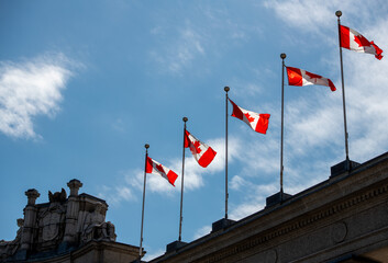 Canadian flags on the top of a building