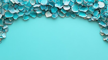A close-up of turquoise and blue chipped paint creating a textured border on a solid turquoise background in natural light