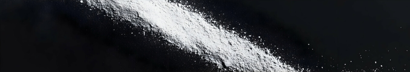 A close-up view of a white powdery substance against a dark background.
