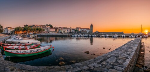 Traditional Catalan Fishing Boats In The Harbor Of The City Of Collioure, With The Church Of...
