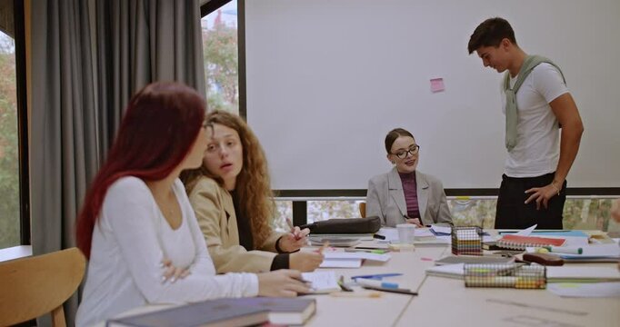 After class, students and their professor collaborate, reviewing notes and sharing insights. Their teamwork drives success and learning together becomes even more effective.