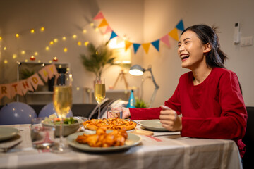 Two Asian women in room with Ciematic lighting celebrate important events such birthdays Christmas