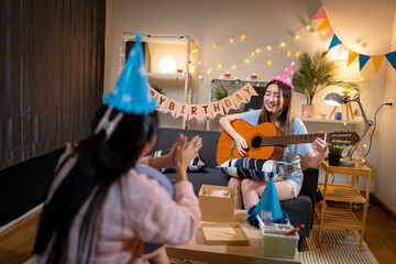 Two Asian women in room with Ciematic lighting celebrate important events such birthdays Christmas