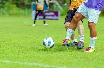 Competitive soccer player aggressively slide tackles toward opposing player