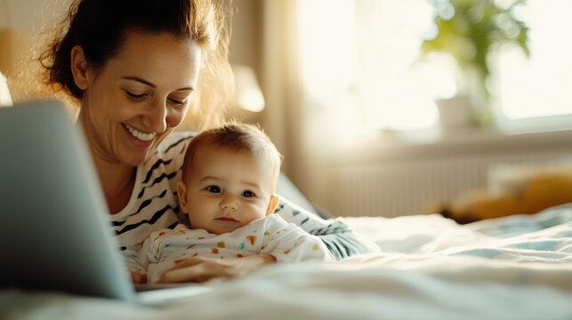 A mother and her baby cuddle comfortably in bed while using a laptop, illustrating a blend of technology and family with a warm, heartfelt moment.