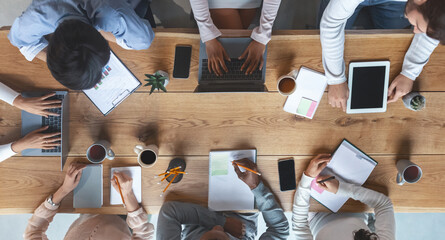 Office lifestyle. International young business team having morning briefing at office, top view