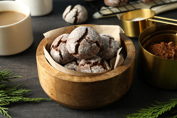 Delicious crinkle cookies in a plate, on a dark background.
