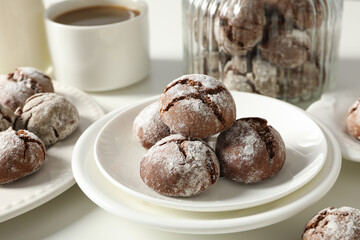 Delicious crinkle cookies in a plate, on a light background.