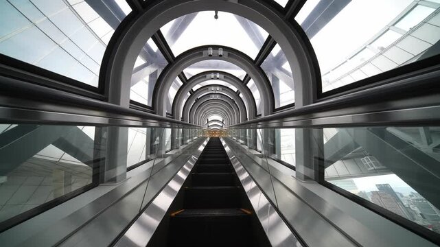 Futuristic tunnel escalator elevator on the move. Osaka city, Japan. Umeda Sky Building tourist attraction. Host city of Expo 2025. 