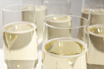 Glasses of champagne on a light background