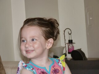 Innocence and Joy: A young girl's radiant smile reflects the purity of childhood, embodying a...