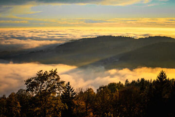 Beautiful landscape in autumn with ground fog in the valley at sunset in Bavarian Forest